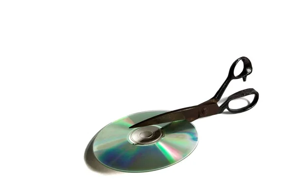 Compact disk cut by scissors on white background. obsolete technology concept — 스톡 사진