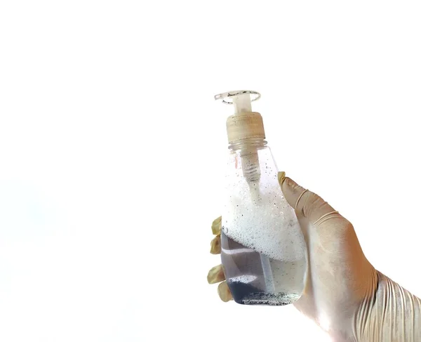 Mano Con Guante Blanco Sosteniendo Una Botella Con Gel Antibacteriano — Foto de Stock