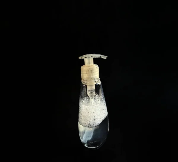 Antibacterial gel bottle on black background. hygiene concept