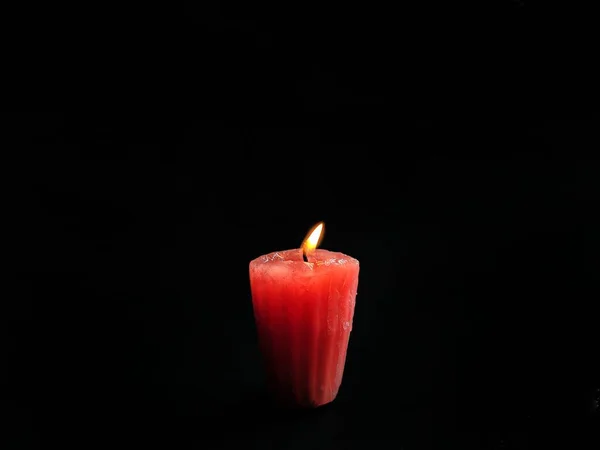 Red candle on black background. romantic concept