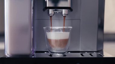 Kahve makinesi sütlü kahve yapar. Bir fincan sıcak cappuccino kahveli kahve makinesi. Sütlü kahve yapan. Gerçek zamanlı görüntüler.