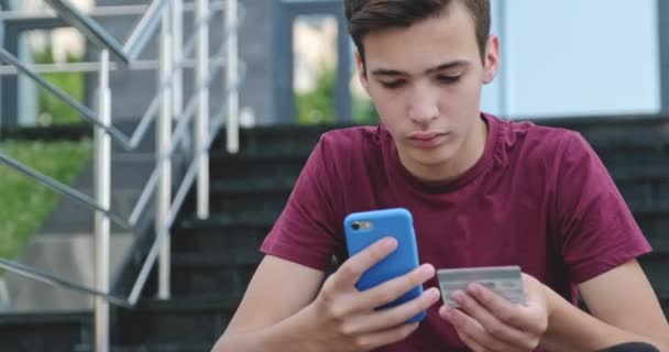 Teen Makes Online Purchases Using Credit Card Mobile Phone Smiling — Stock Video