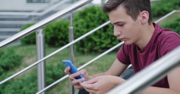 Teen Makes Online Purchases Using Credit Card Mobile Phone Smiling — Stock Video