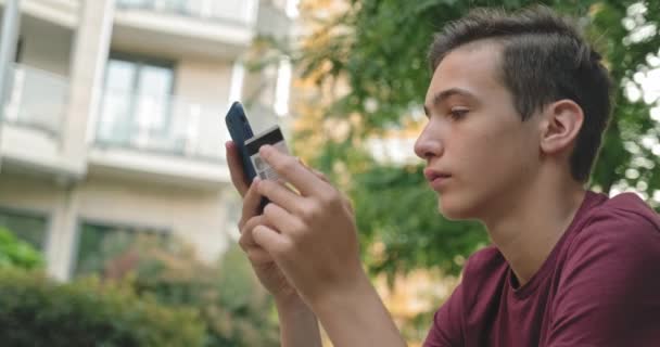 Teen Makes Online Purchases Using Credit Card Mobile Phone Smiling — Stock Video