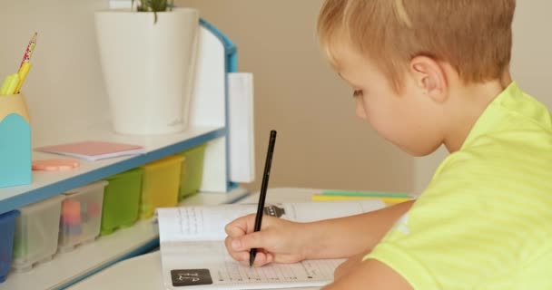 Child Writes Letters School Notebook Schoolboy Doing Homework Home Handwriting — Stock Video