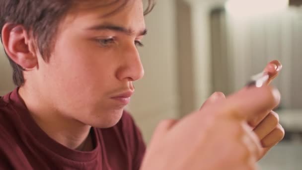 Close Gezicht Van Een Tiener Jongen Met Smartphone Thuis Blanke — Stockvideo