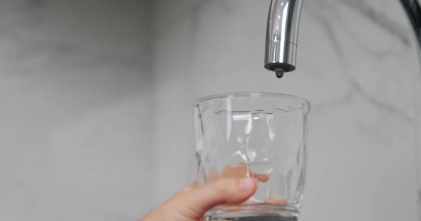 Hand Child Holds Transparent Cup Kitchen Tap Dripping Water Child — Stock Video