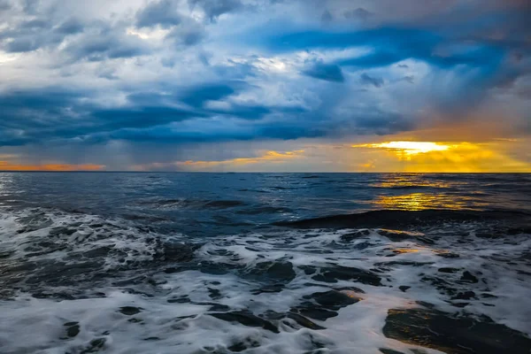 Before the storm sunset on the sea, the sky is tightened with heavy clouds, great excitement at sea, the Arctic.