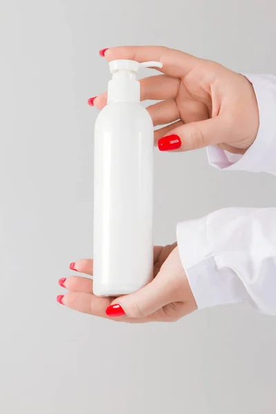 Hand hold blank white tube mock up isolated empty cream bottle m
