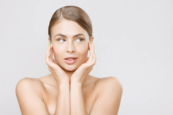 Beautiful young woman face close up studio on grey background