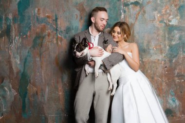 Genç gelin ve damat köpek bir arada tutan ayakta