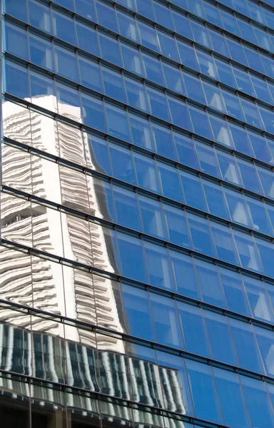 Spiegelbild eines Bürohochhauses mit blauem Himmel — Stockfoto