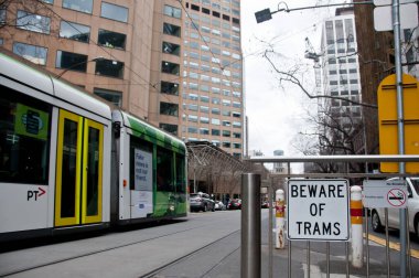 MELBOURNE, AUSTRALIA - JULY 26, 2018: Beware of Tram sign with Melbourne tram in Melbourne Victoria Australia