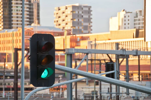 Green light traffic signal with contemporary train station background