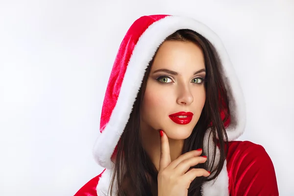 Christmas Santa hat woman portrait hold christmas gift. Smiling happy girl on blue background. Portrait of beautiful sexy girl wearing santa claus clothes. — Stock Photo, Image