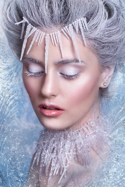 Snow Queen.Fantasy girl portrait. Winter fairy portrait.Young woman  with creative silver artistic make-up. Winter Portrait. Stock Picture