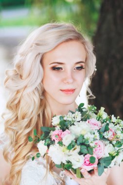 Güzel gelin. Düğün saç ve makyaj. Genç gelin buketi tutan gelinlik
