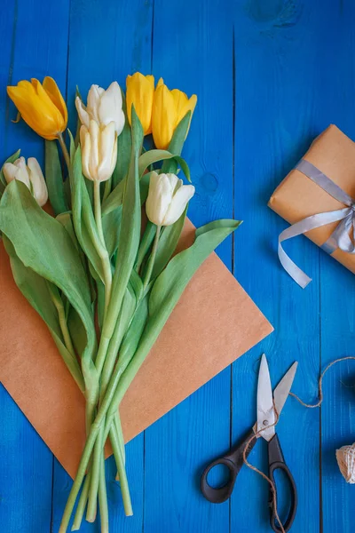 Making a bouquet of white and yellow tulips at home