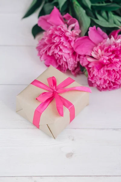 Mooie frisse roze pioen bloem met de doos van de gift op houten achtergrond. Pioenrozen zomer. Moeders of Womens dag — Stockfoto
