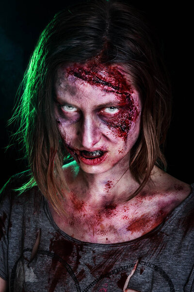Close-up portrait of horrible zombie woman with wounds. Horror. Halloween poster.