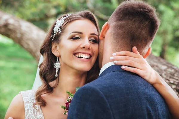 Beau couple de mariage dans le parc. Ils s'embrassent et s'embrassent — Photo