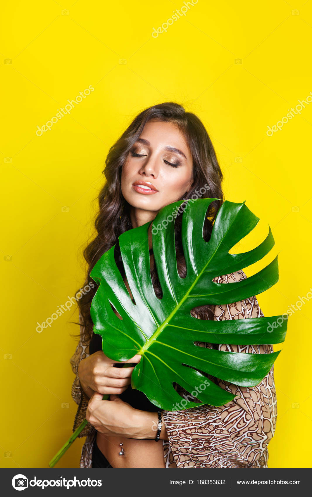 Beautiful sexy indian woman in bikini with tropical plants. Beauty