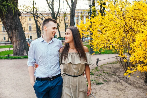 Casal romântico ter uma data em um dia de primavera com belas flores no fundo. Data romântica ou conceito de casal viajante — Fotografia de Stock