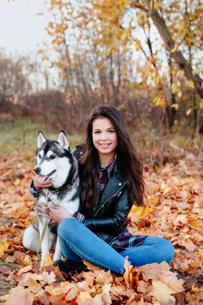 Lycklig kvinna njuter av en dag i höstparken med sin hund — Stockfoto