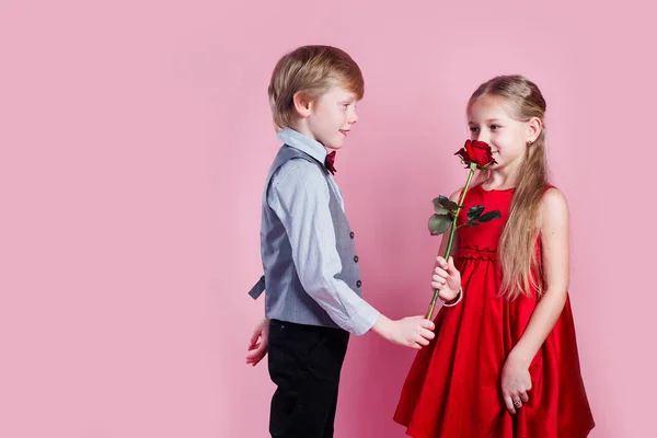 Boy in love giving cute girl red rose , Valentines day surprise — 스톡 사진