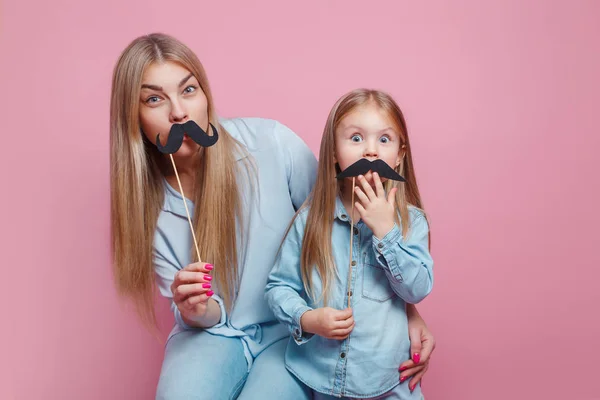Mother and her daughter girl holding paper mustache on sticks. — 스톡 사진