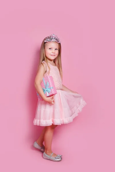 Μικρή πριγκίπισσα κορίτσι στο στέμμα κρατώντας κουτί δώρου — Φωτογραφία Αρχείου