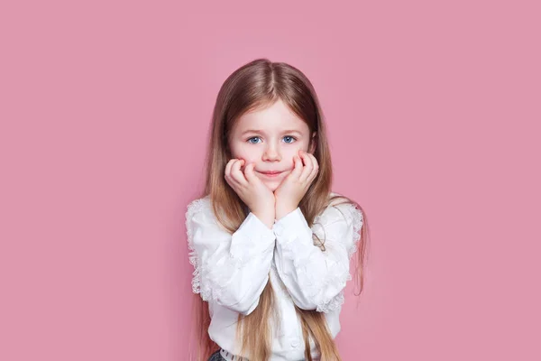 Очаровательная очаровательная маленькая девочка держит руки под подбородком — стоковое фото
