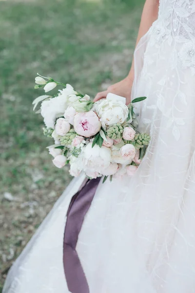 Rustic wedding bouquet on wedding dress background outdoor