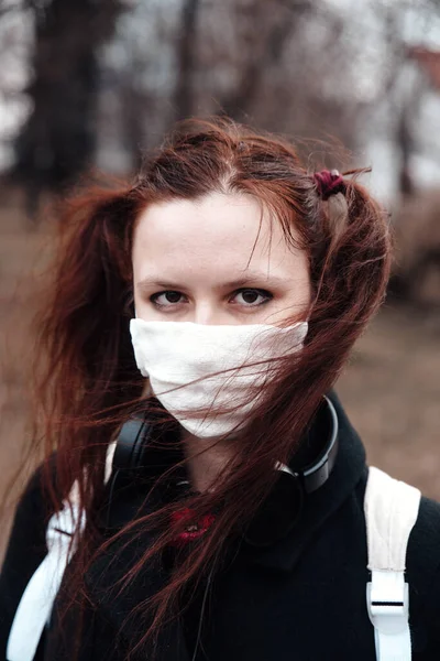 Close-up of young woman with surgical mask on face against SARS-CoV-2 and Coronavirus — Stock Photo, Image