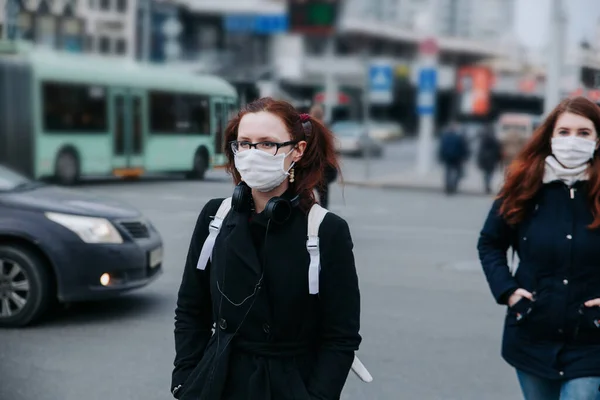 Young woman with face mask in the street