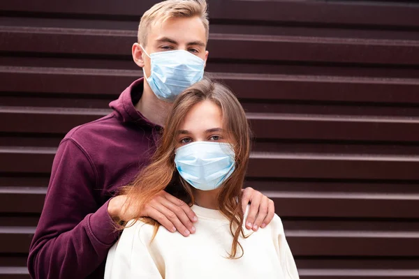 Two people in masks hugging.Couple being divided by incurable infectious disease