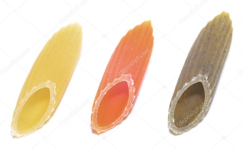 colorful Italian raw Pasta MEZZE PENNE TRICOLORE three pieces laid out in a row. Close up. tricolour. white background.
