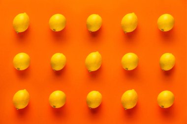 turuncu arka planda limon vitamini deseni