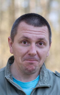 Yüzünde duygularını açıkça ifade eden bir adamın fotoğrafı.