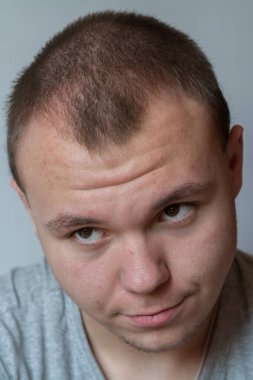 Genç adam yüzünde farklı duygular ifade ediyor. .