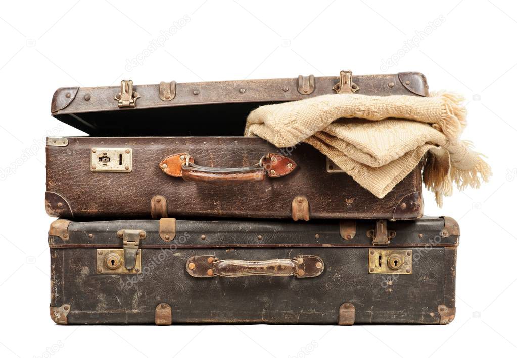 Old suitcase with blankets inside isolated on white background