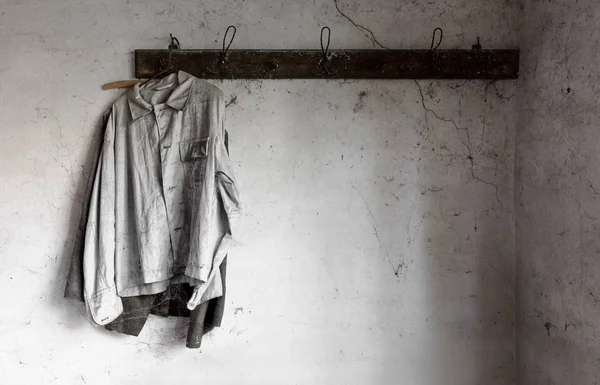 Old dirty shirts on hanger in an old garage