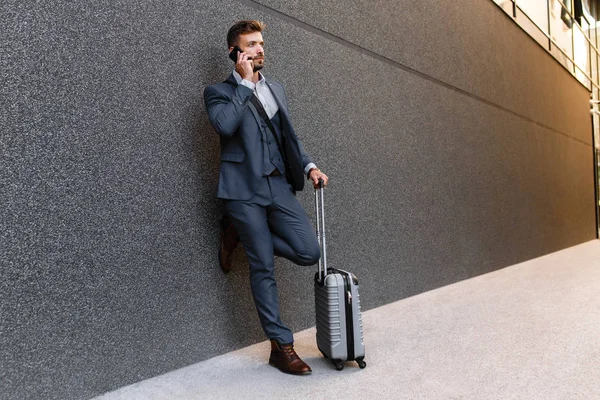 businessman with luggage outdoor portrait