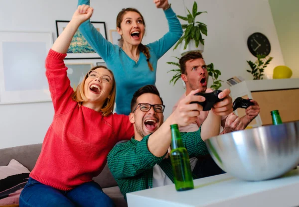 Group of friends watching football on tv