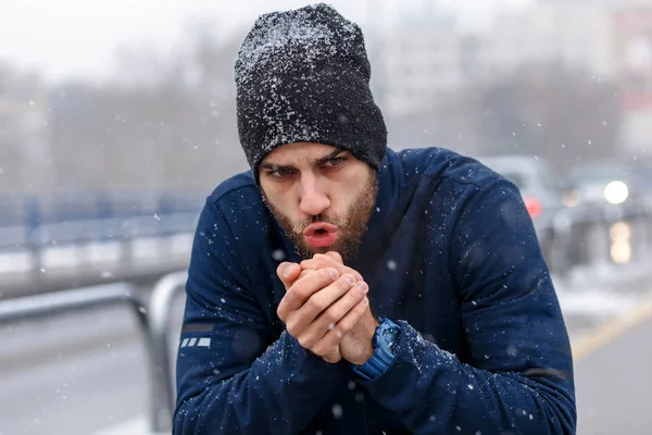 Young athlete hands warming in cold winter weather