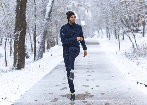Young athlete doing warm-up in cold winter weather
