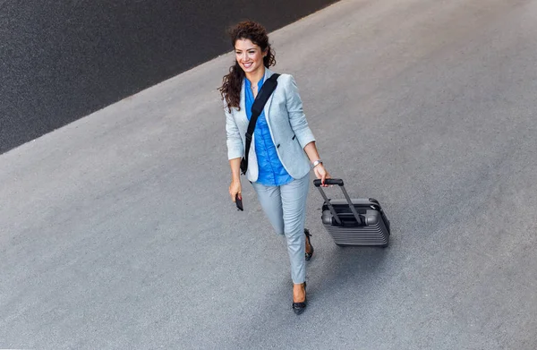 Elegant and beautiful woman with luggage case