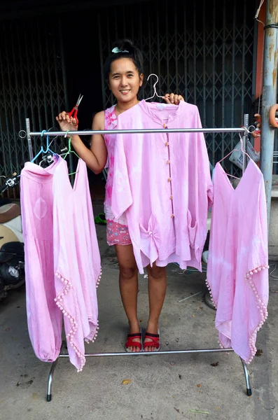 Thai woman people working process dry clothes in the sun tie bat