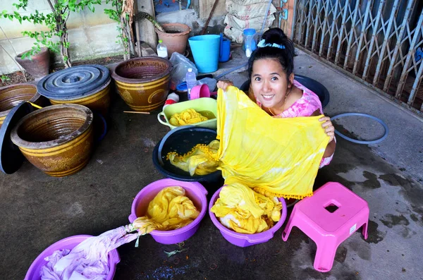 Thai women washing and clean clothes after tie batik dyeing natu
