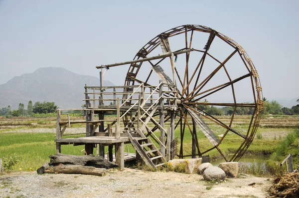 Big wooden turbine baler water wheel at Thai Dam Cultural Villag